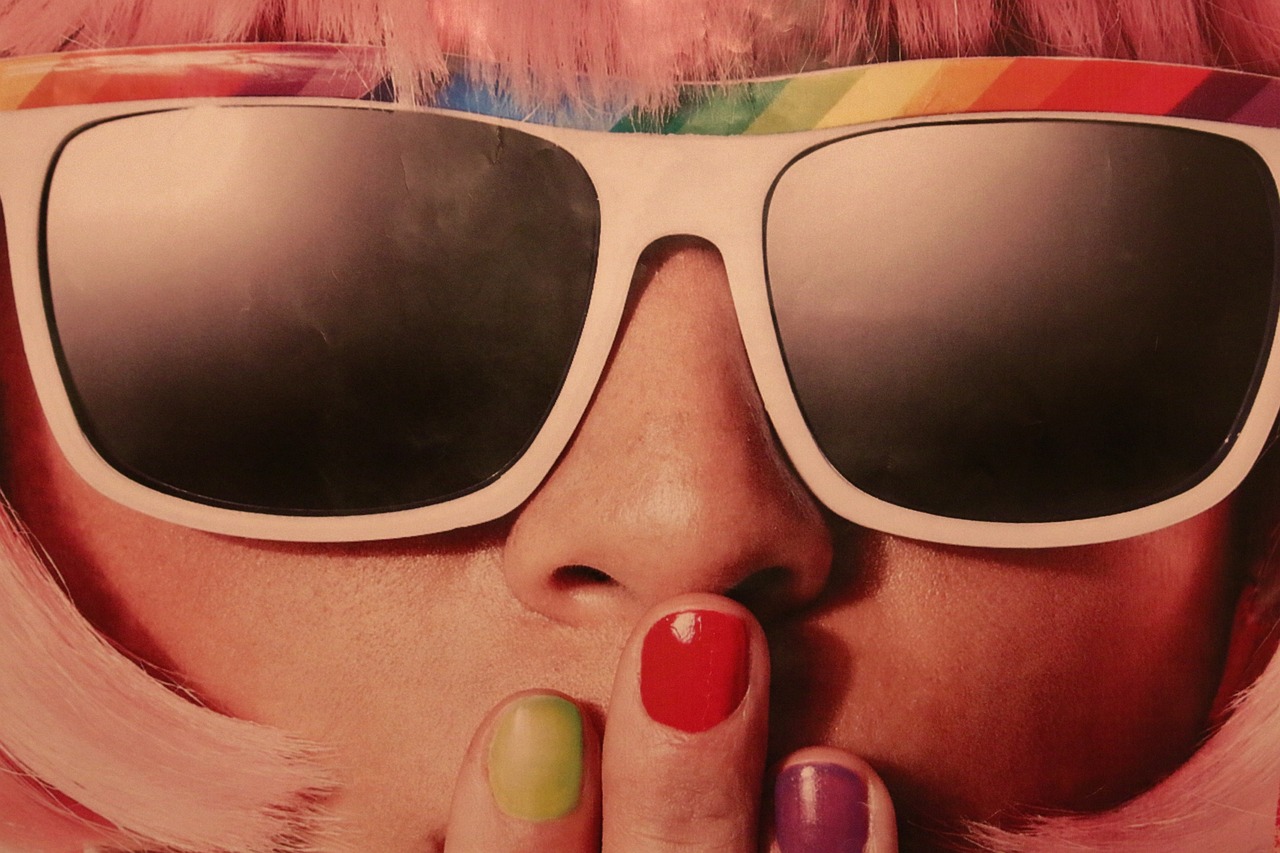Frau mit Sonnenbrille, hält sich Hand mit lackierten Nägeln vor den Mund © ©Ulrike Mai/Pixabay